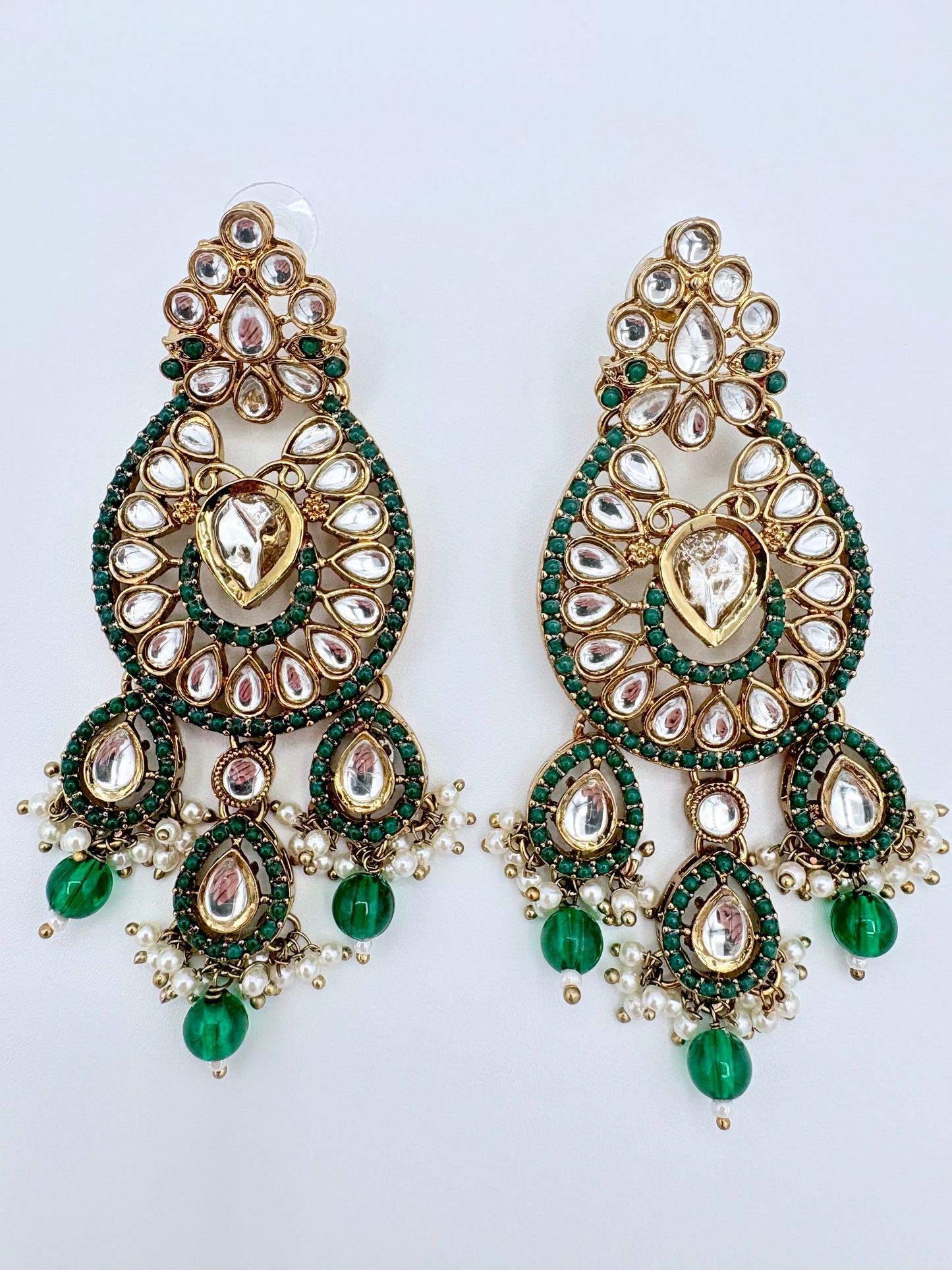 Ornate earrings with green and gold details available at Nishaani.ca – Indian jewelry in Canada