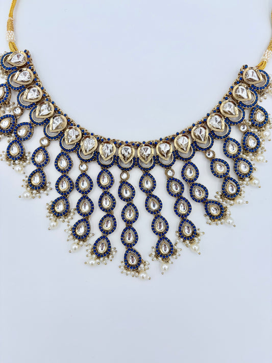 Ornate necklace with blue and gold accents on a light gray background available at Nishaani.ca – Indian jewelry in Canada