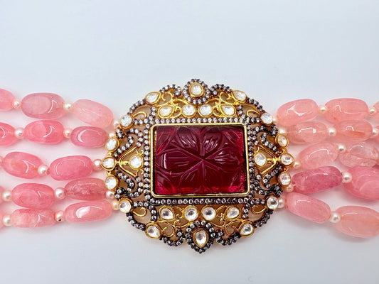 Jewelry with pink beads and a decorative red gemstone available at Nishaani.ca – Indian jewelry in Canada