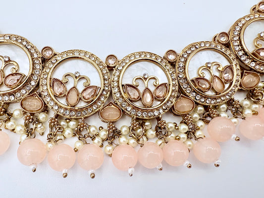 Ornate jewelry piece with gold elements and pink beads available at Nishaani.ca – Indian jewelry in Canada