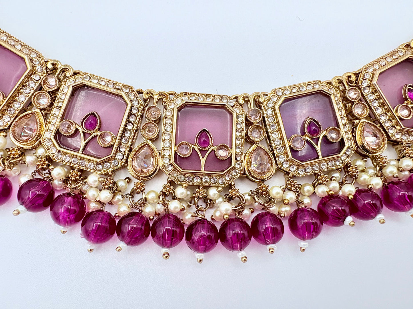 Ornate necklace with pink stones and gold accents available at Nishaani.ca – Indian jewelry in Canada
