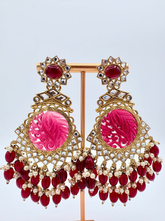Ornate earrings with pink central stones and red beads available at Nishaani.ca – Indian jewelry in Canada