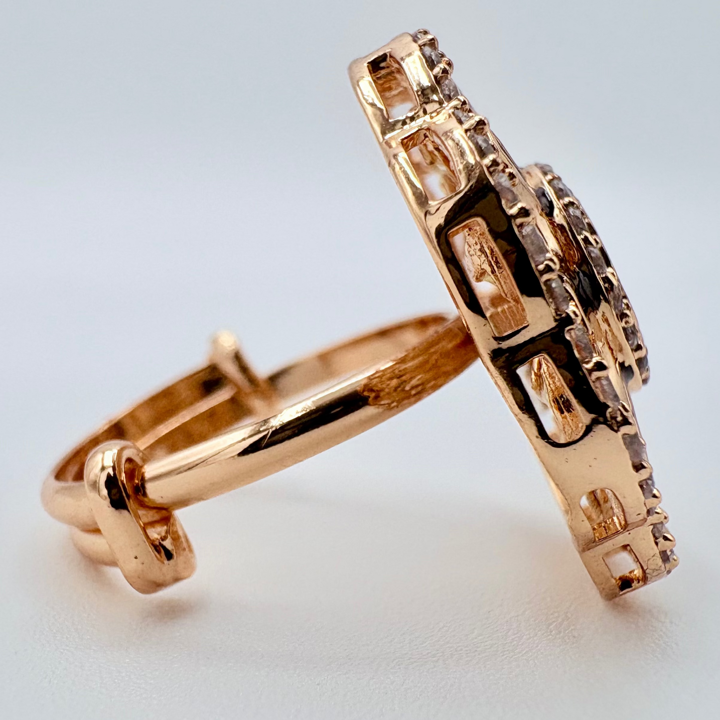 Rose gold ring with intricate design on a light gray background available at Nishaani.ca – Indian jewelry in Canada