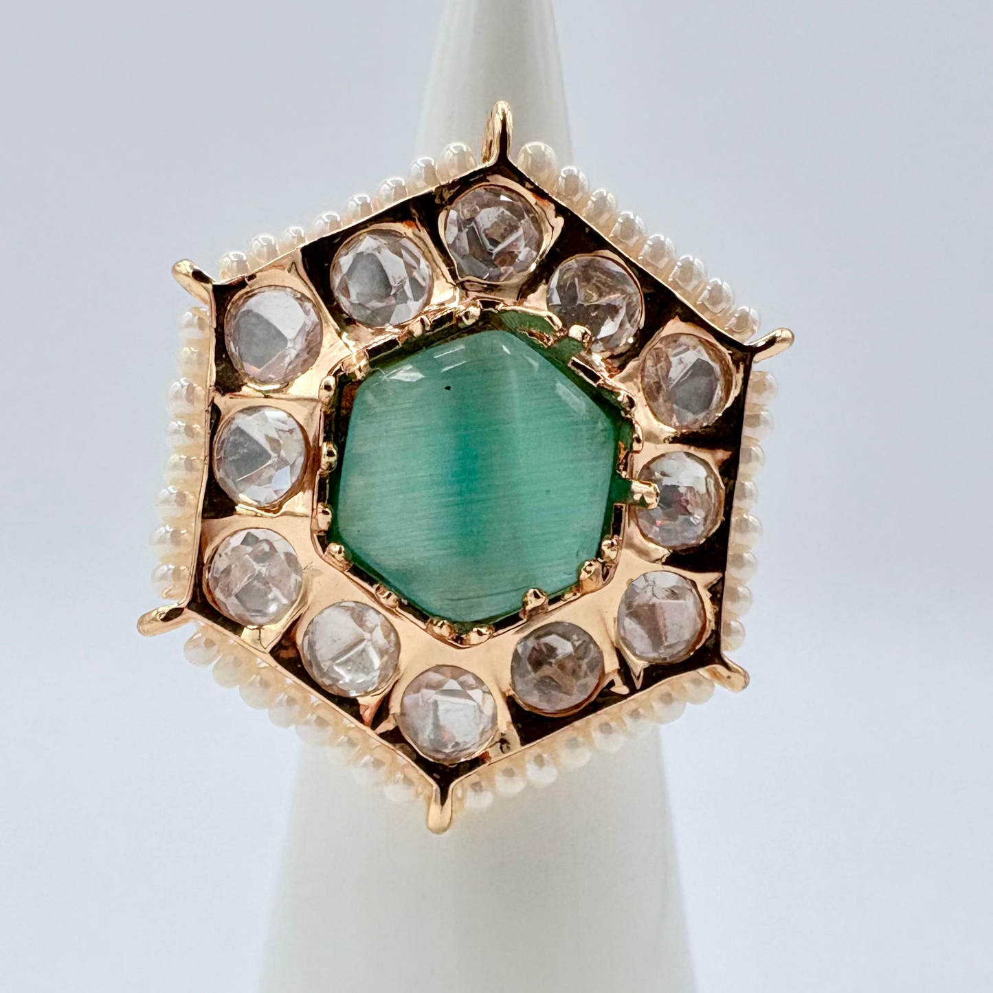 Gold ring with a icy blue gemstone surround by small crystal gems available at Nishaani.ca – Indian jewelry in Canada