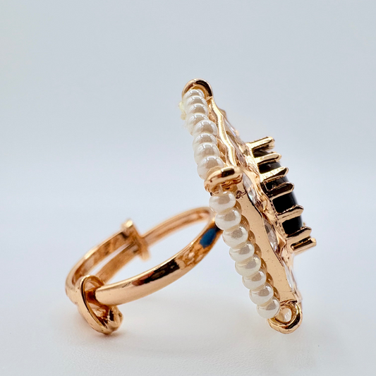 Side view Gold ring with a navy blue gemstone surround by small crystal gems available at Nishaani.ca – Indian jewelry in Canada