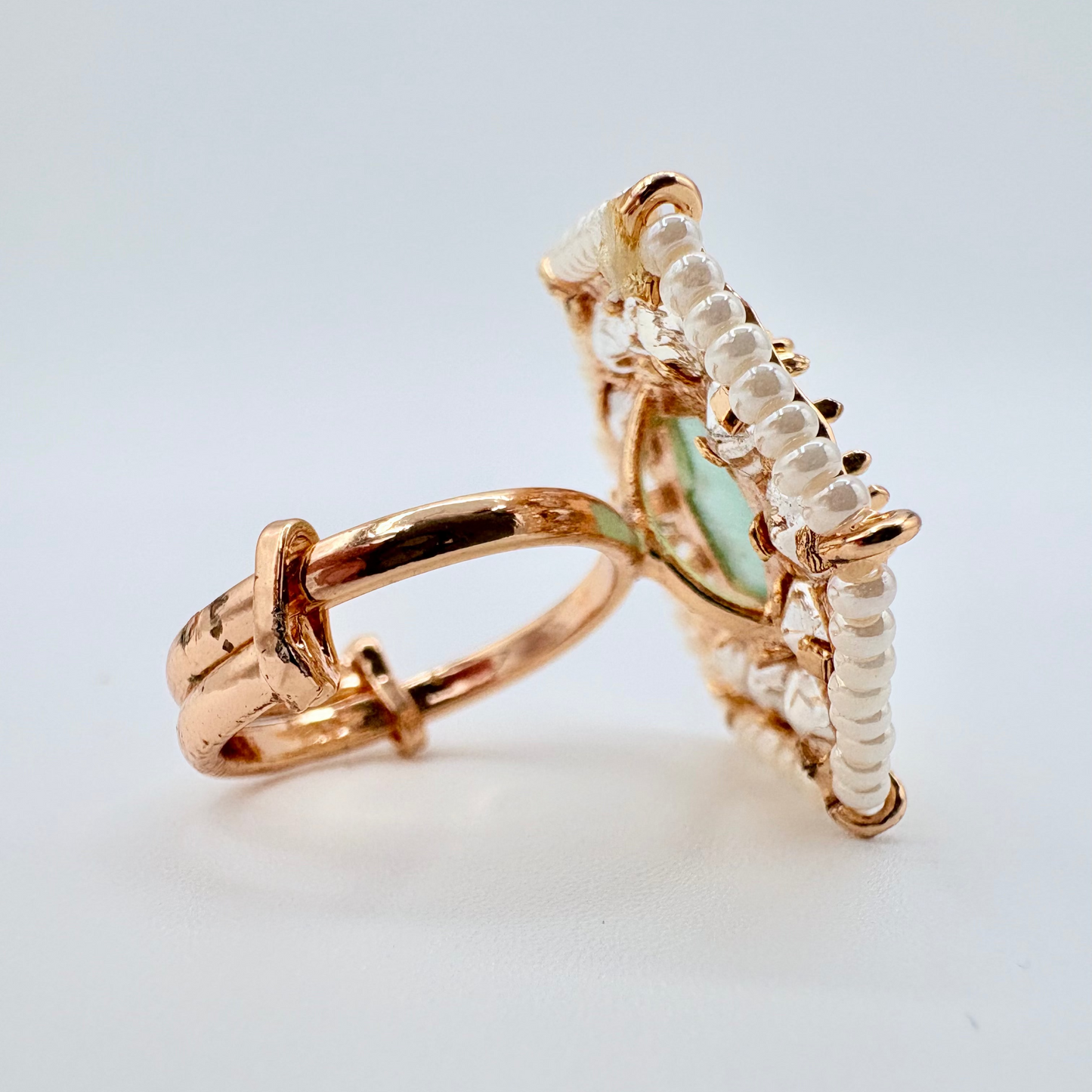 Rose gold ring with a green gemstone available at Nishaani.ca – Indian jewelry in Canada