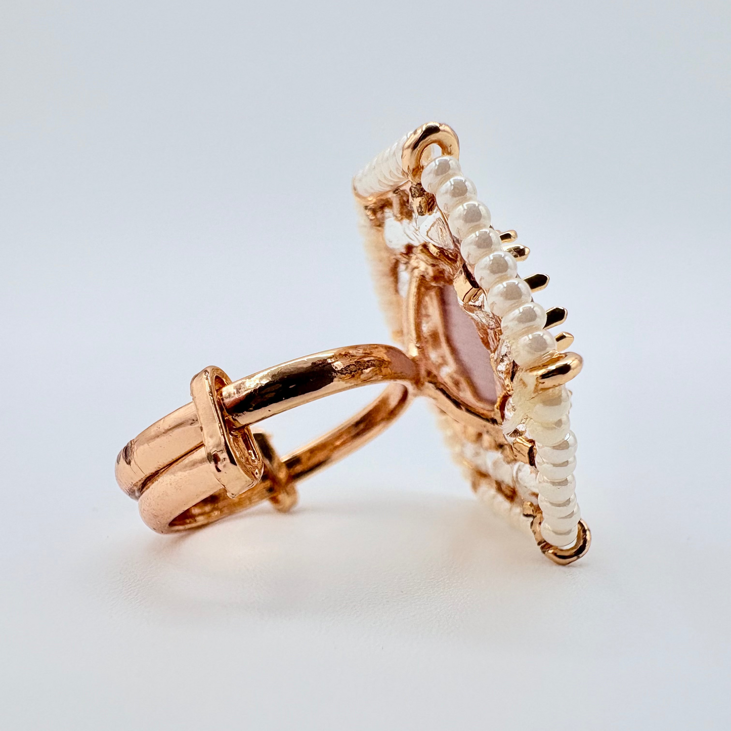 side view Gold ring with a rose gemstone surround by small crystal gems available at Nishaani.ca – Indian jewelry in Canada