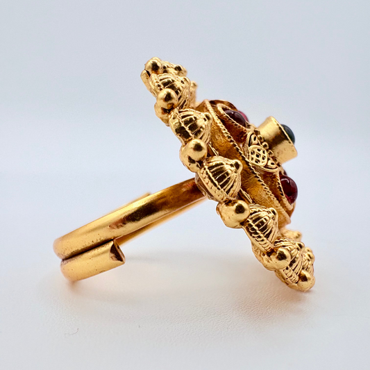 Gold ring with intricate design and red gemstones Decorative gold ring with colored stones available at Nishaani.ca – Indian jewelry in Canada