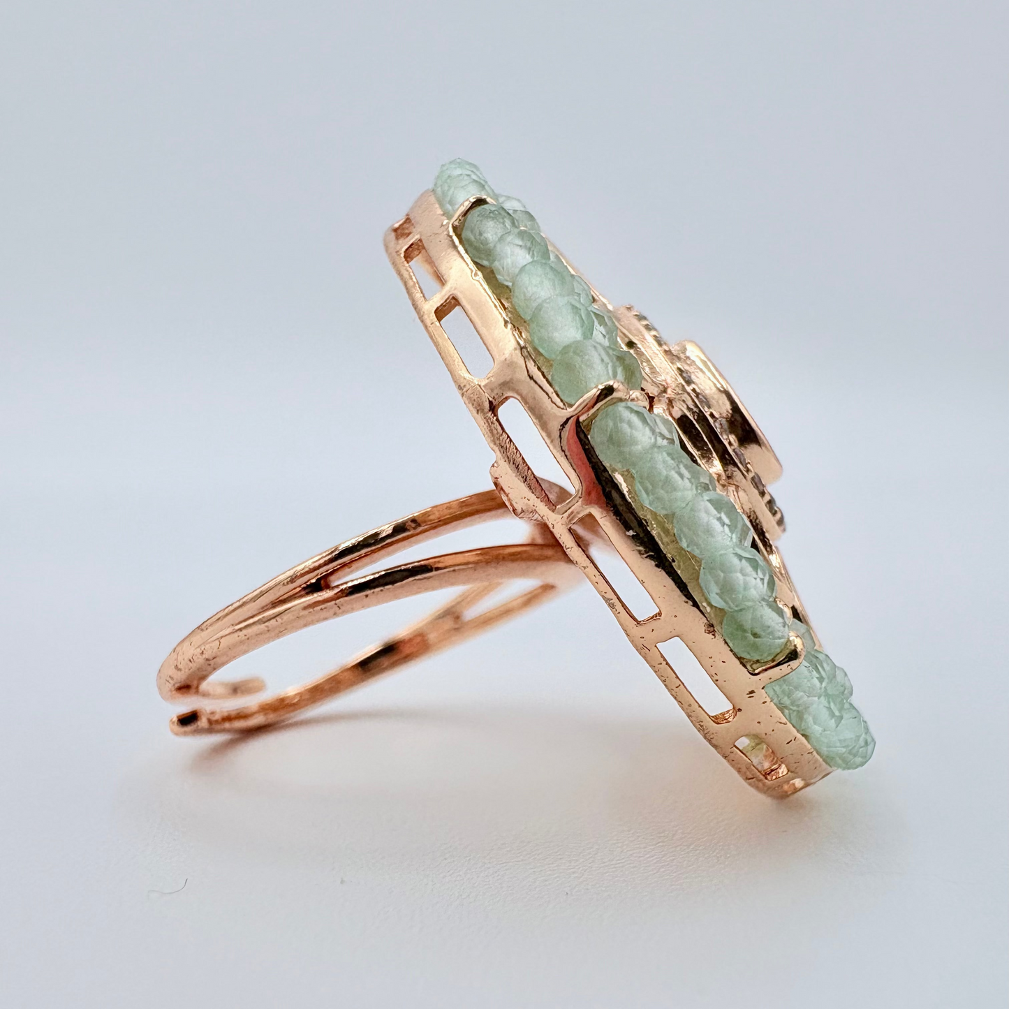 Rose gold ring with green gemstones available at Nishaani.ca – Indian jewelry in Canada