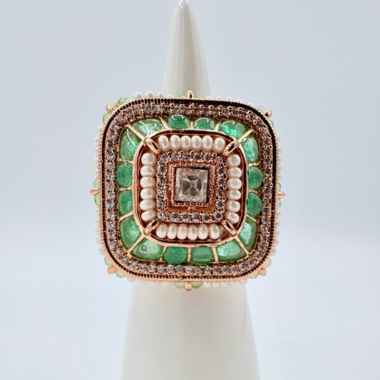 Decorative ring with green gemstones and gold accents available at Nishaani.ca – Indian jewelry in Canada