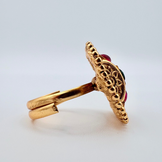 Gold ring with a red gemstone available at Nishaani.ca – Indian jewelry in Canada