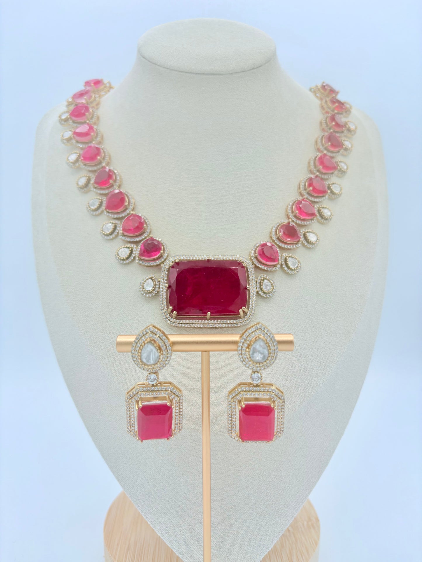 Jewelry set with pink gemstones on a mannequin bust available at Nishaani.ca – Indian jewelry in Canada