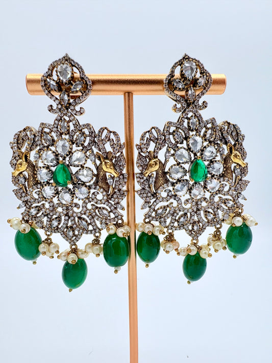 Ornate earrings with green gemstones available at Nishaani.ca – Indian jewelry in Canada