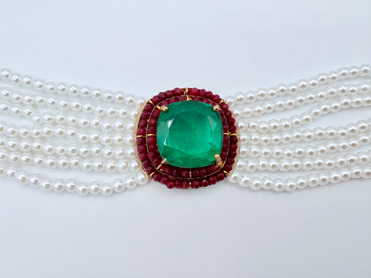 Pearl necklace with a green gemstone and red accents available at Nishaani.ca – Indian jewelry in Canada