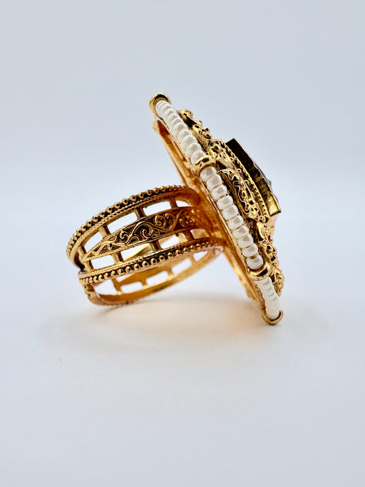 Gold ring with intricate design on a light available at Nishaani.ca – Indian jewelry in Canada
