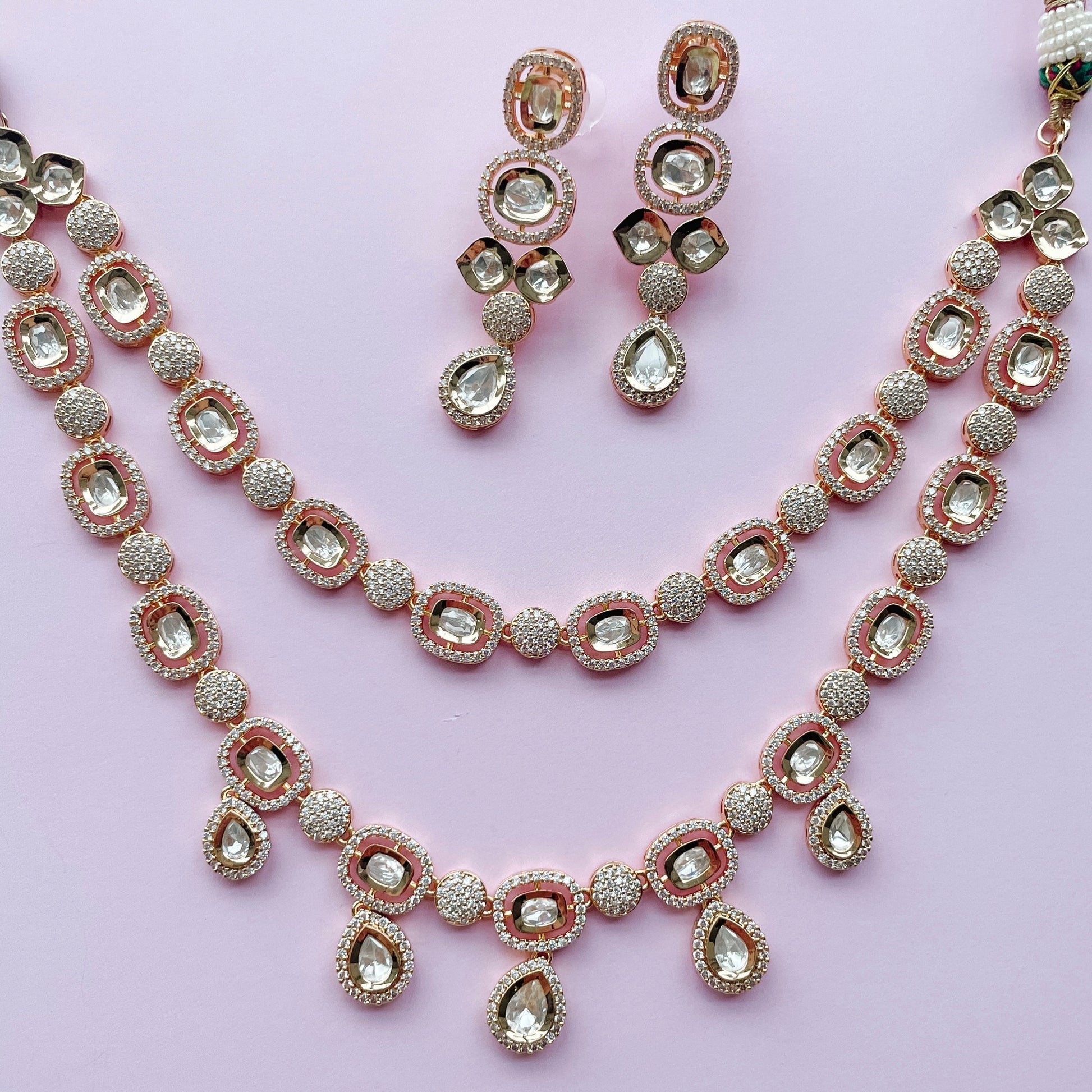 A double strand of pearl and crystal drop earrings with rose gold-colored metal clasps.