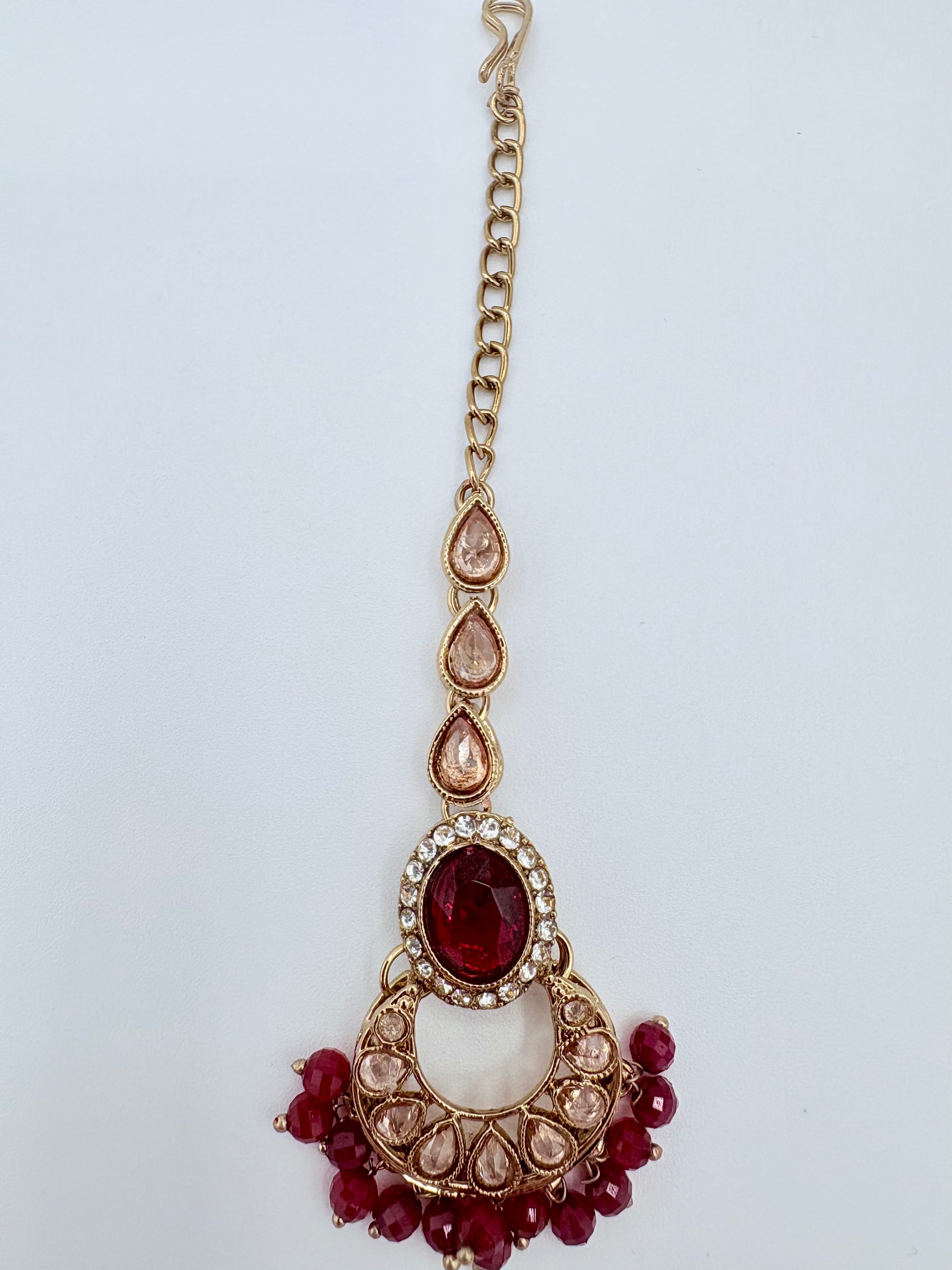 Tikka with red gemstones and gold chain available at Nishaani.ca – Indian jewelry in Canada