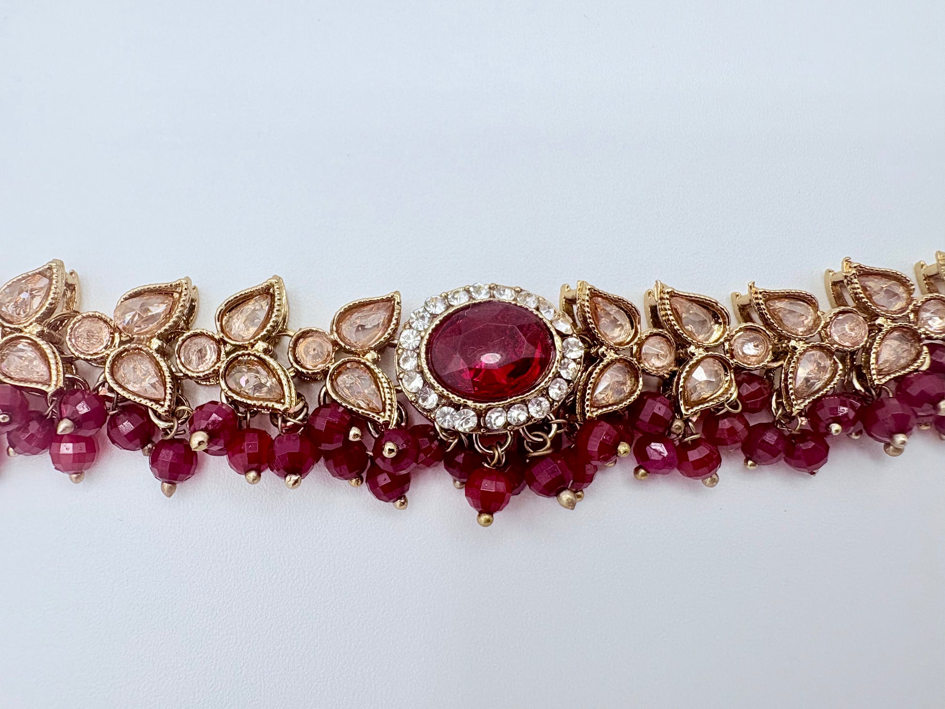 Choker necklace  bracelet with red gemstones and gold accents available at Nishaani.ca – Indian jewelry in Canada