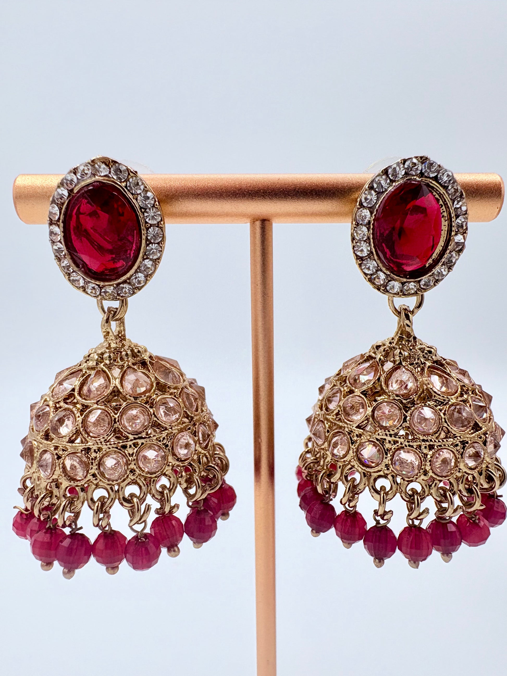 Pair of ornate earrings with red gemstones available at Nishaani.ca – Indian jewelry in Canada