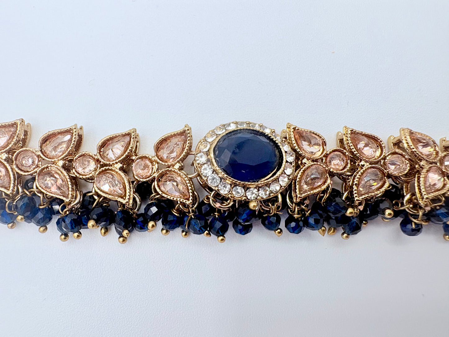 Choker necklace with blue gemstone and gold accents available at Nishaani.ca – Indian jewelry in Canada