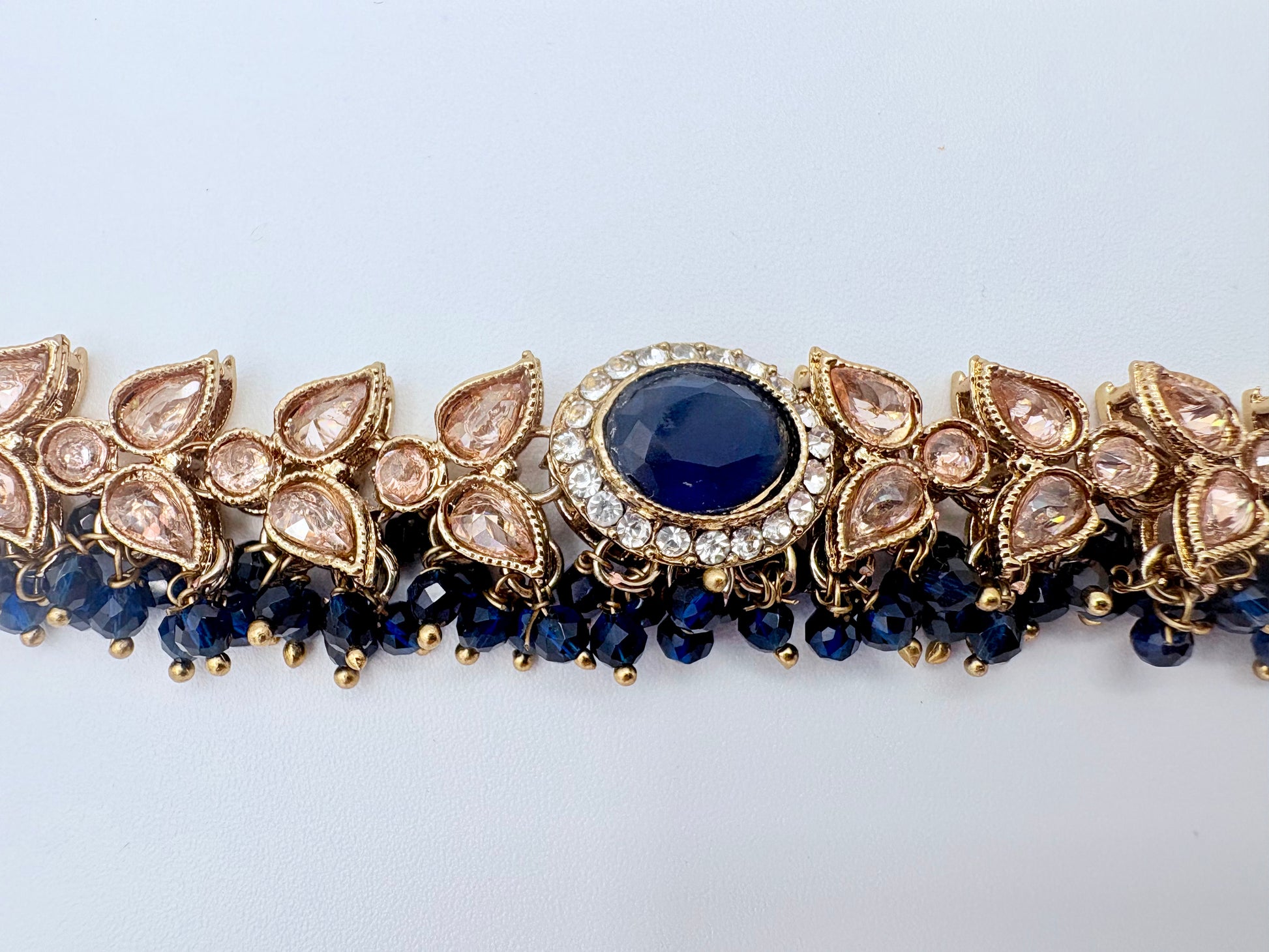 Choker necklace with blue gemstone and gold accents available at Nishaani.ca – Indian jewelry in Canada