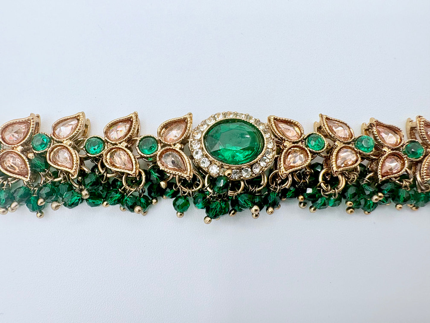 Choker necklace with green gemstones and gold accents available at Nishaani.ca – Indian jewelry in Canada