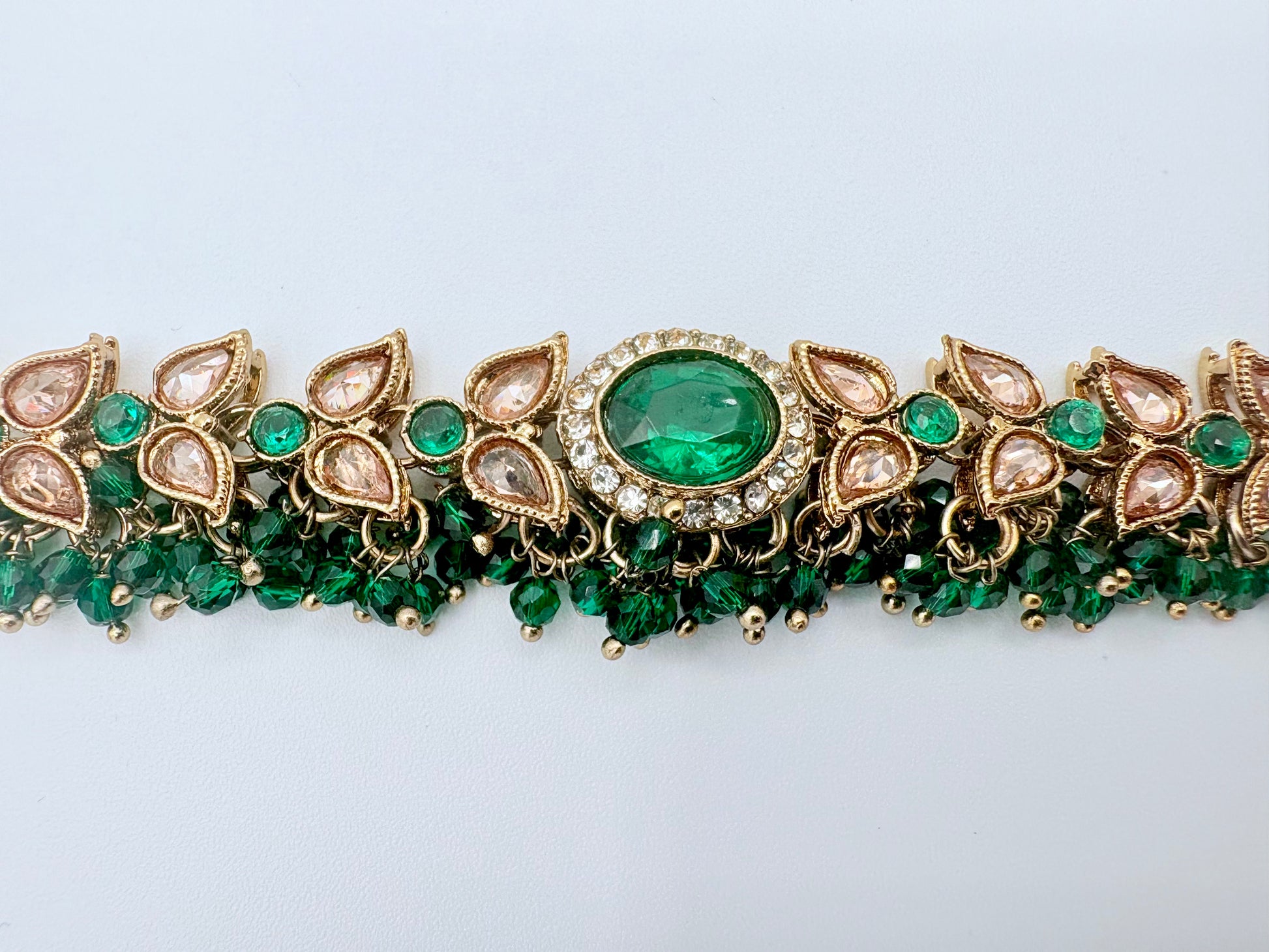 Choker necklace with green gemstones and gold accents available at Nishaani.ca – Indian jewelry in Canada
