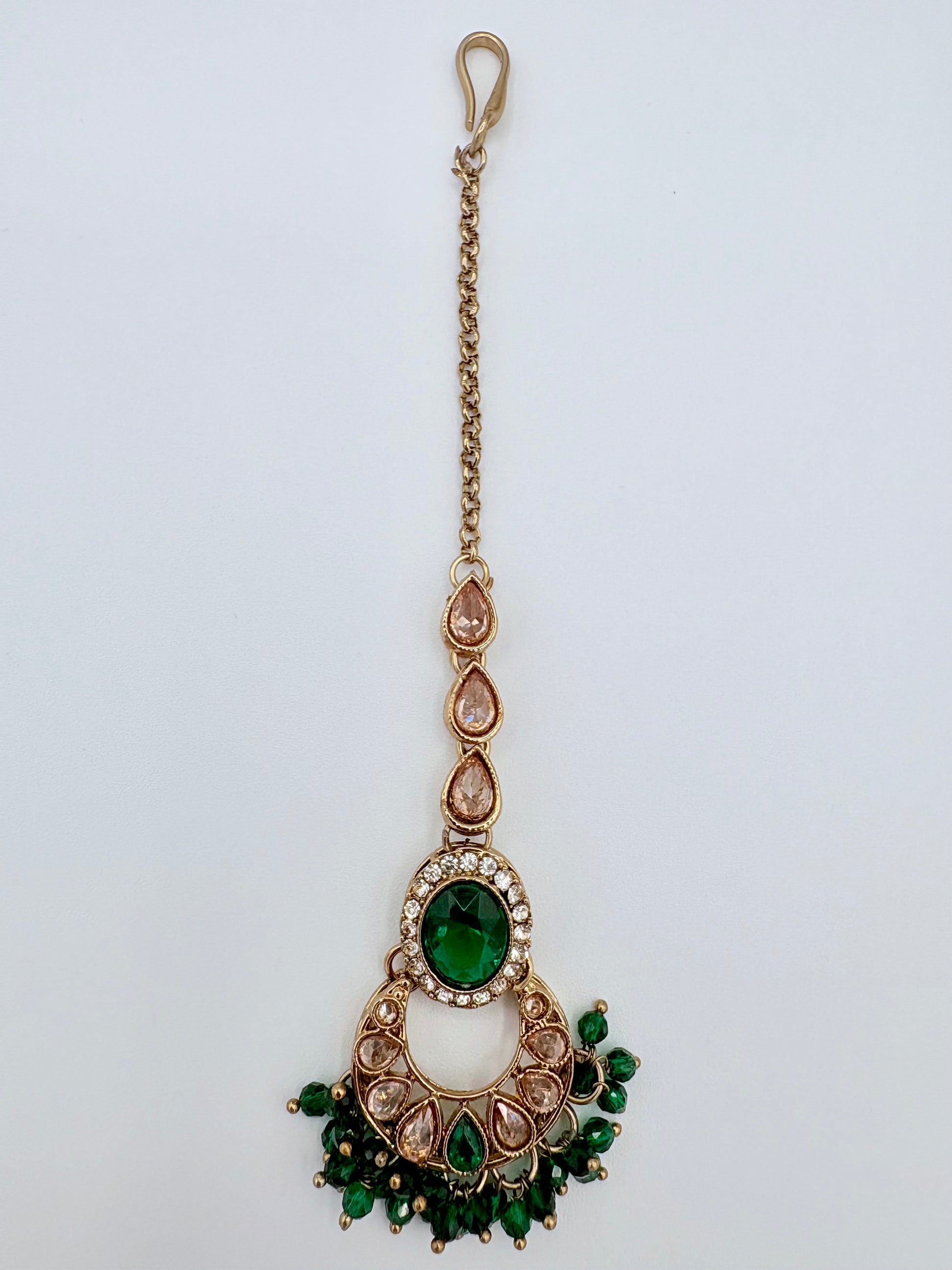 Tikka with green gemstones and gold chain available at Nishaani.ca – Indian jewelry in Canada