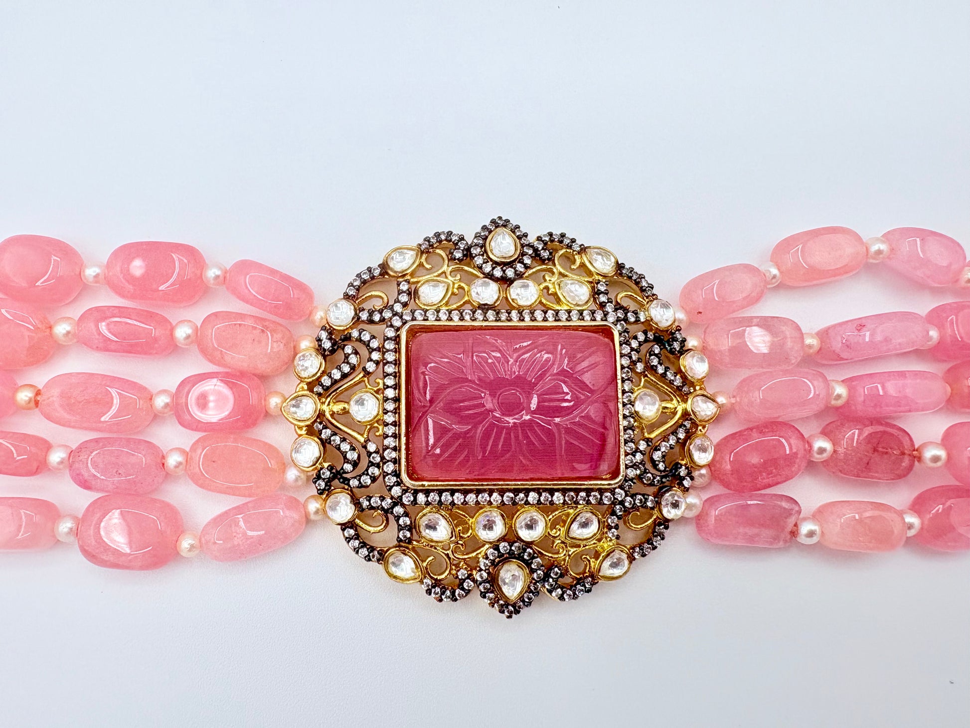 Pink beaded necklace with a decorative pink and gold clasp available at Nishaani.ca – Indian jewelry in Canada