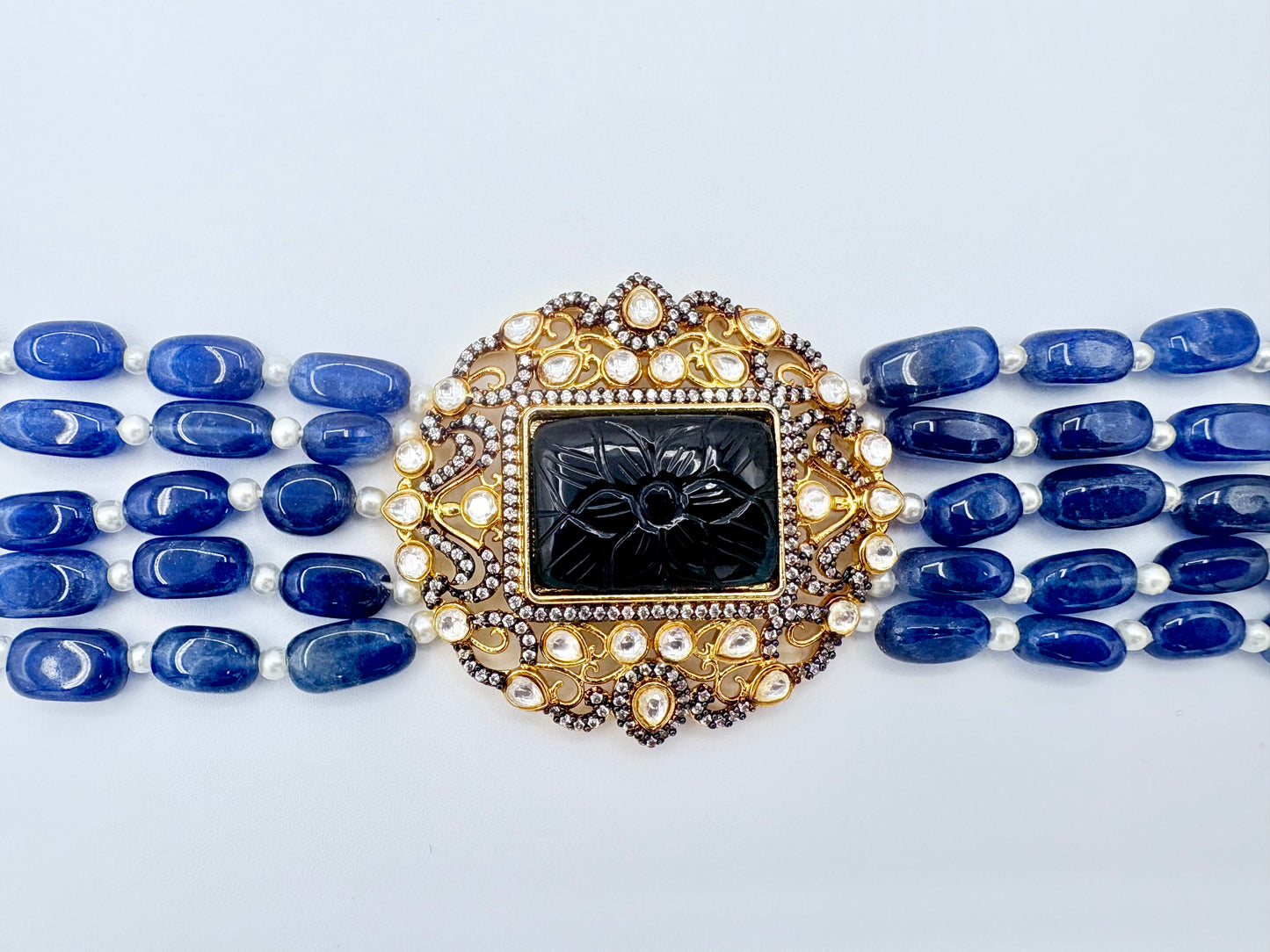 Decorative necklace with blue beads and a gold and black clasp available at Nishaani.ca – Indian jewelry in Canada