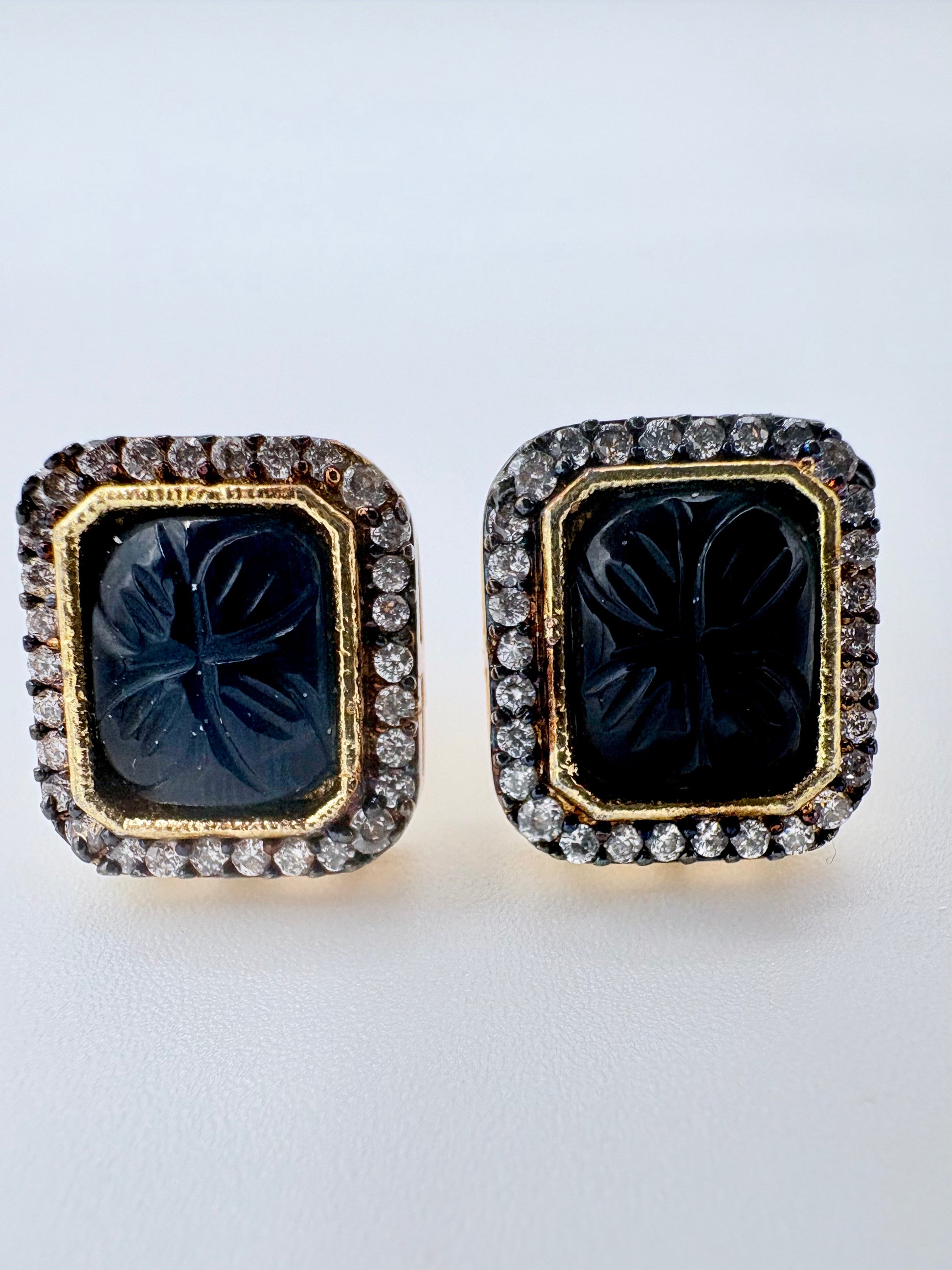 Pair of earrings with black gemstones and gold frames available at Nishaani.ca – Indian jewelry in Canada