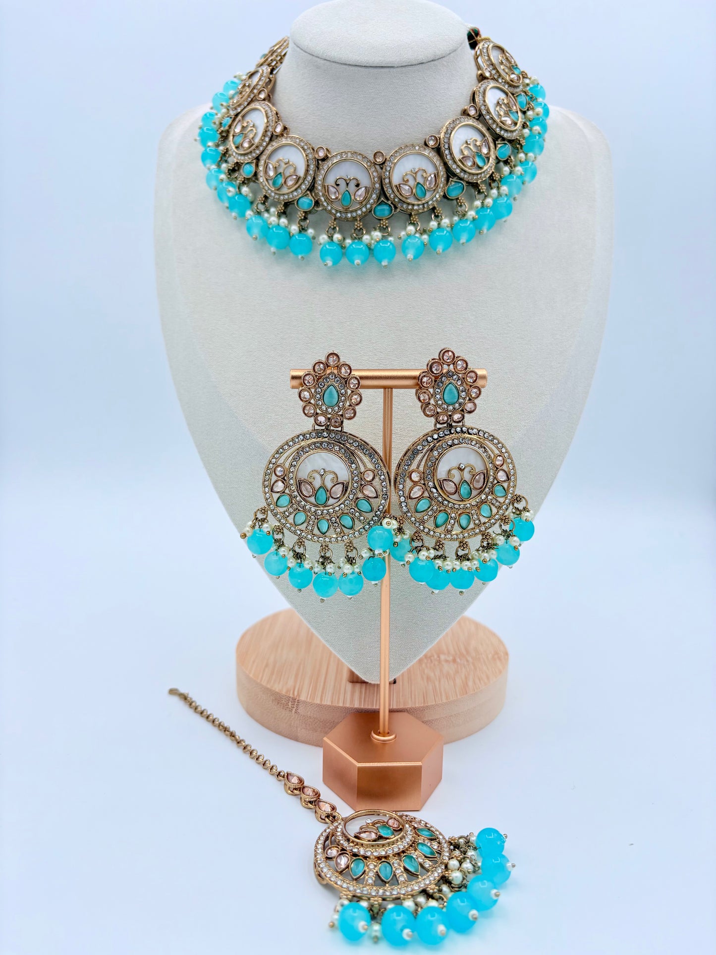 Jewelry set with turquoise beads and gold accents on a mannequin bust available at Nishaani.ca – Indian jewelry in Canada