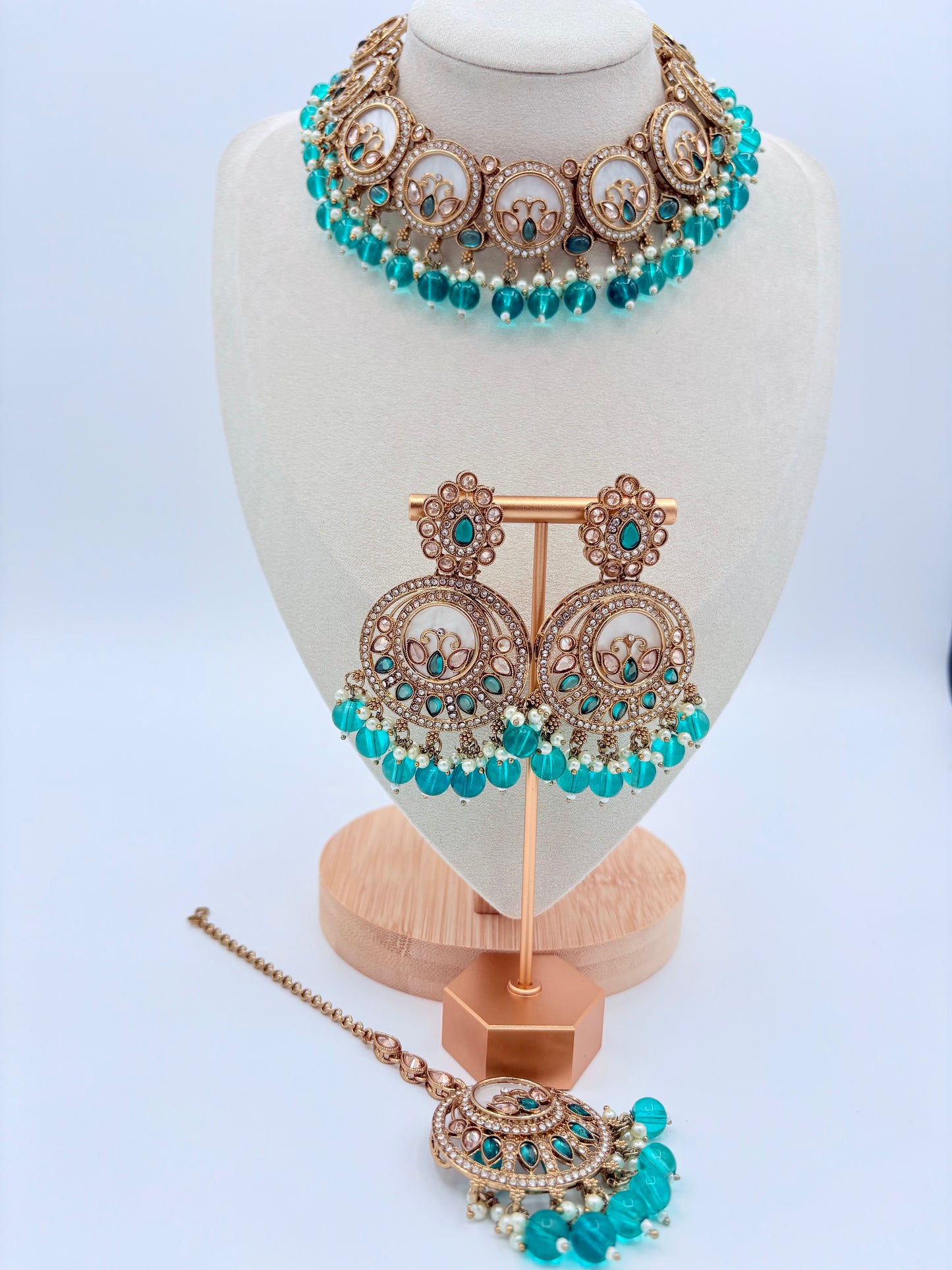 Jewelry set with necklace, earrings, and tikka on a mannequin bust available at Nishaani.ca – Indian jewelry in Canada
