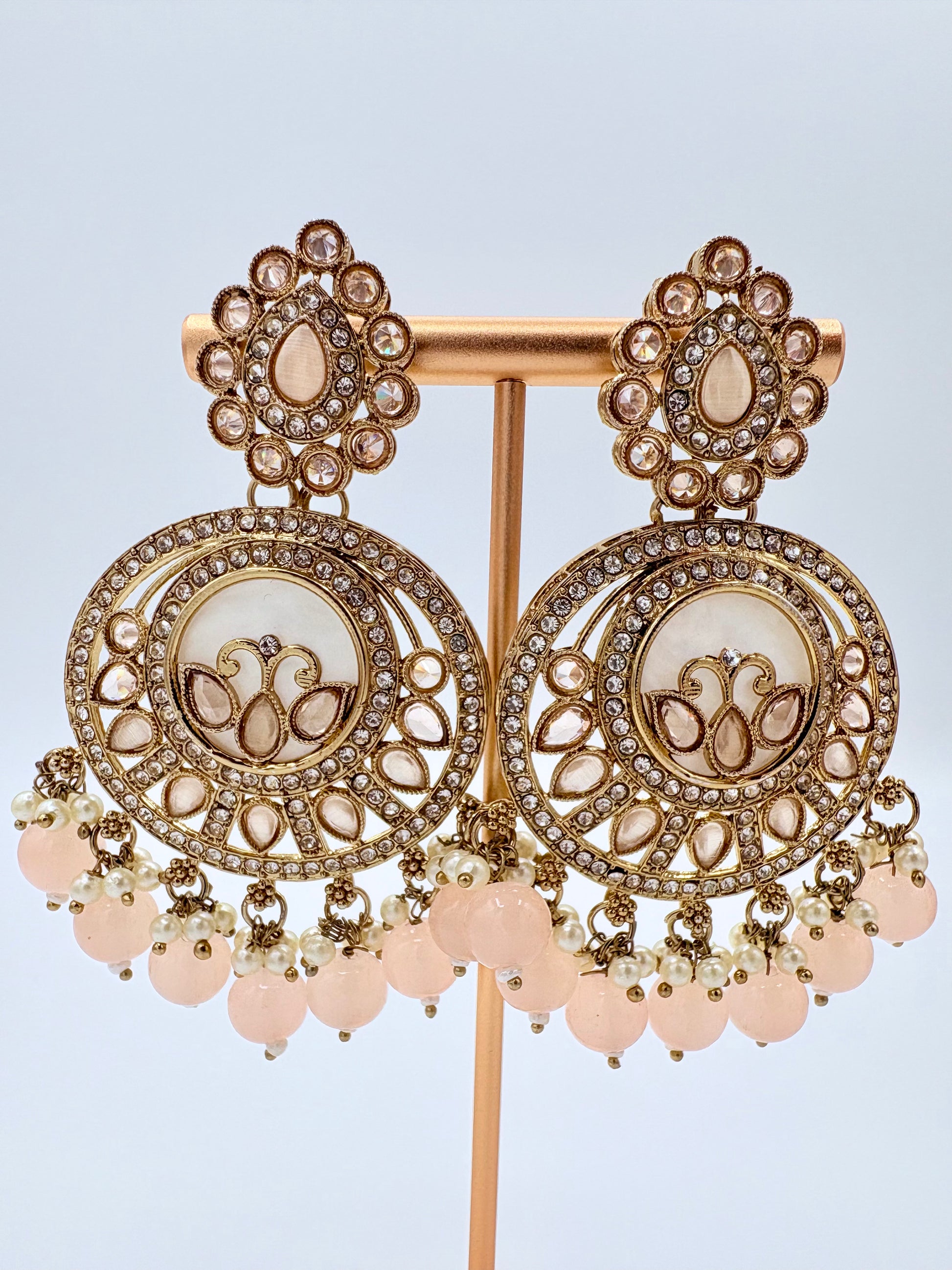 Ornate gold and peach earrings available at Nishaani.ca – Indian jewelry in Canada
