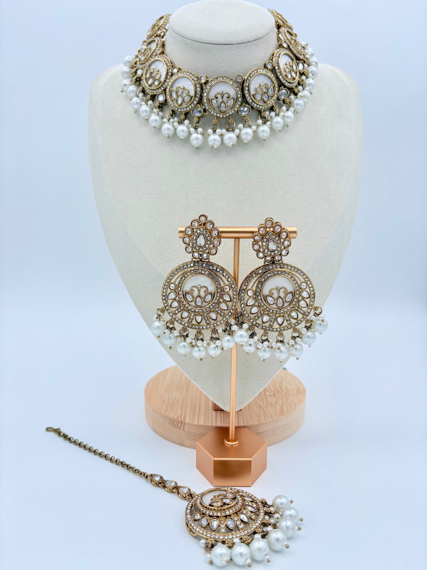 Jewelry set with necklace, earrings, and tikka on a mannequin bust available at Nishaani.ca – Indian jewelry in Canada