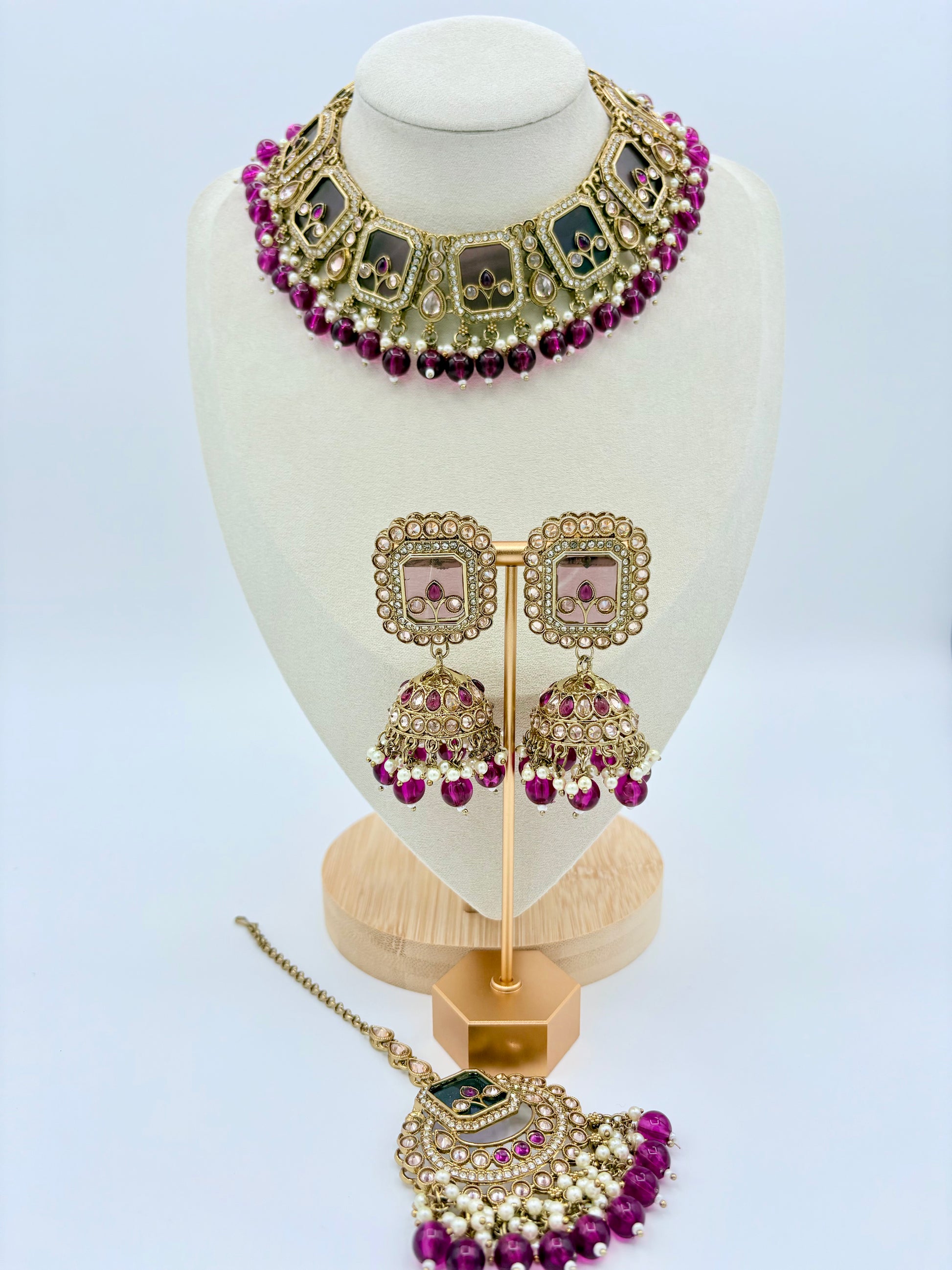 Jewelry set including necklace, earrings, and tikka on a mannequin bust available at Nishaani.ca – Indian jewelry in Canada