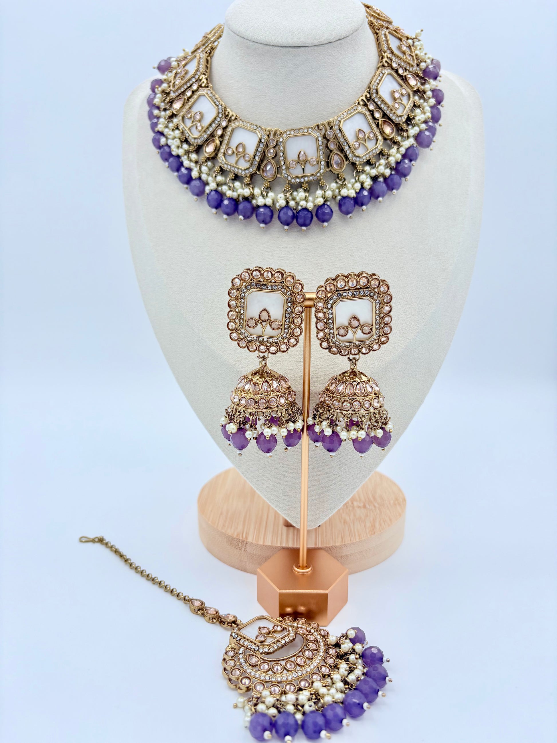 Jewelry set including necklace, earrings, and tikka on a mannequin bust available at Nishaani.ca – Indian jewelry in Canada