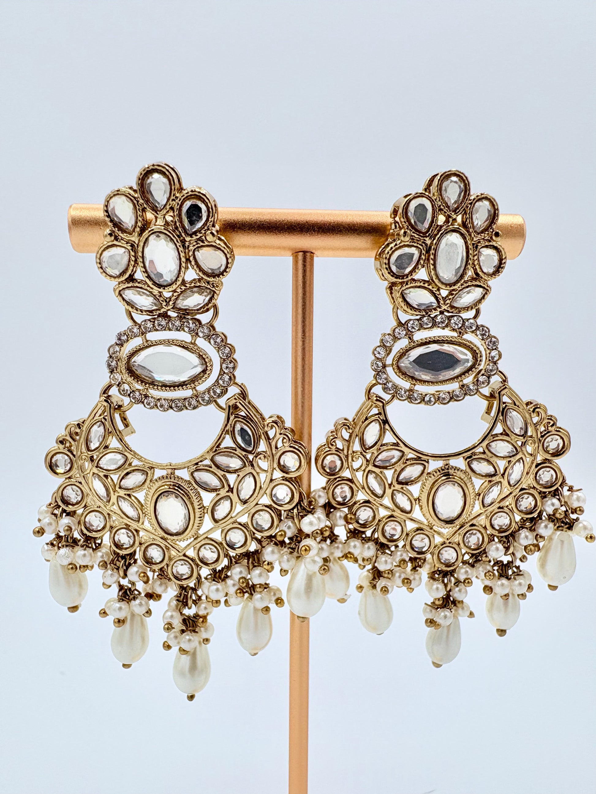 Ornate gold earrings with gemstones available at Nishaani.ca – Indian jewelry in Canada