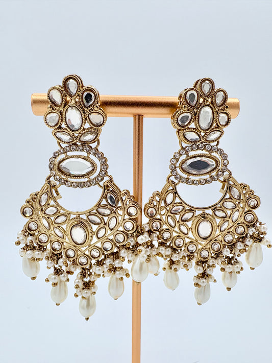 Ornate gold earrings with gemstones available at Nishaani.ca – Indian jewelry in Canada