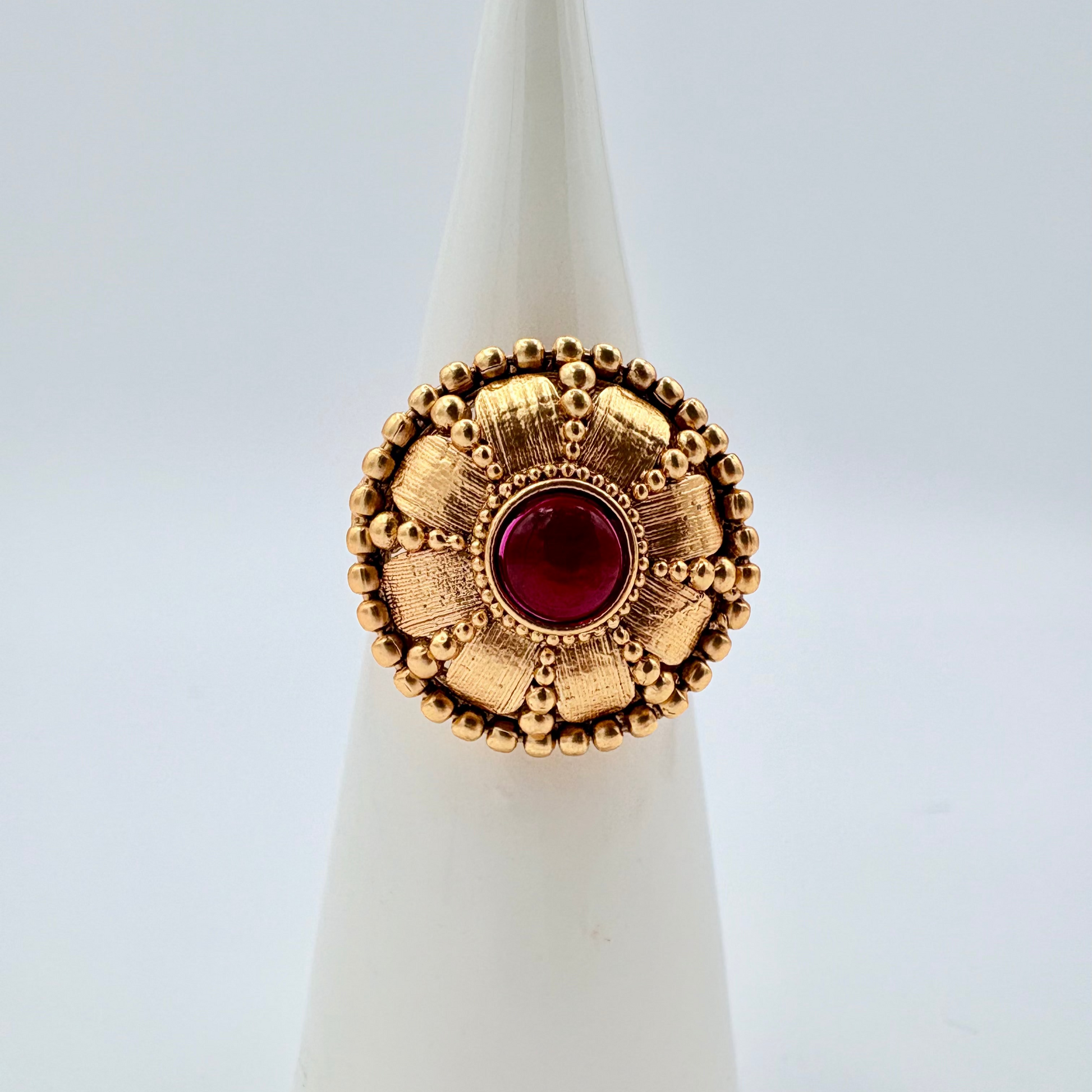 Gold ring with a red gemstone available at Nishaani.ca – Indian jewelry in Canada