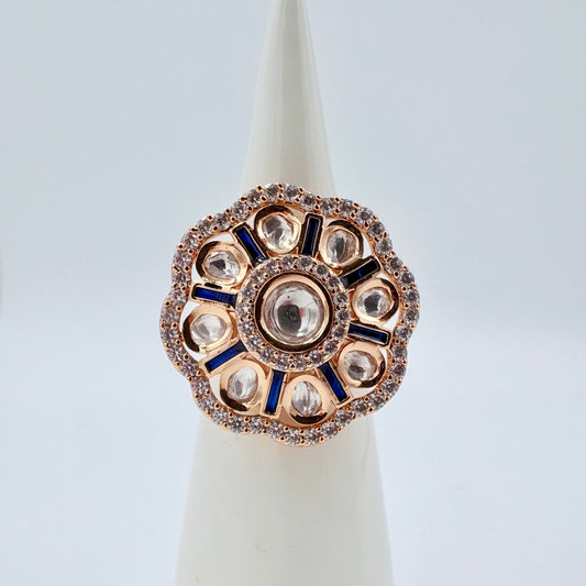 Decorative ring with rose gold and blue accents on a white available at Nishaani.ca – Indian jewelry in Canada