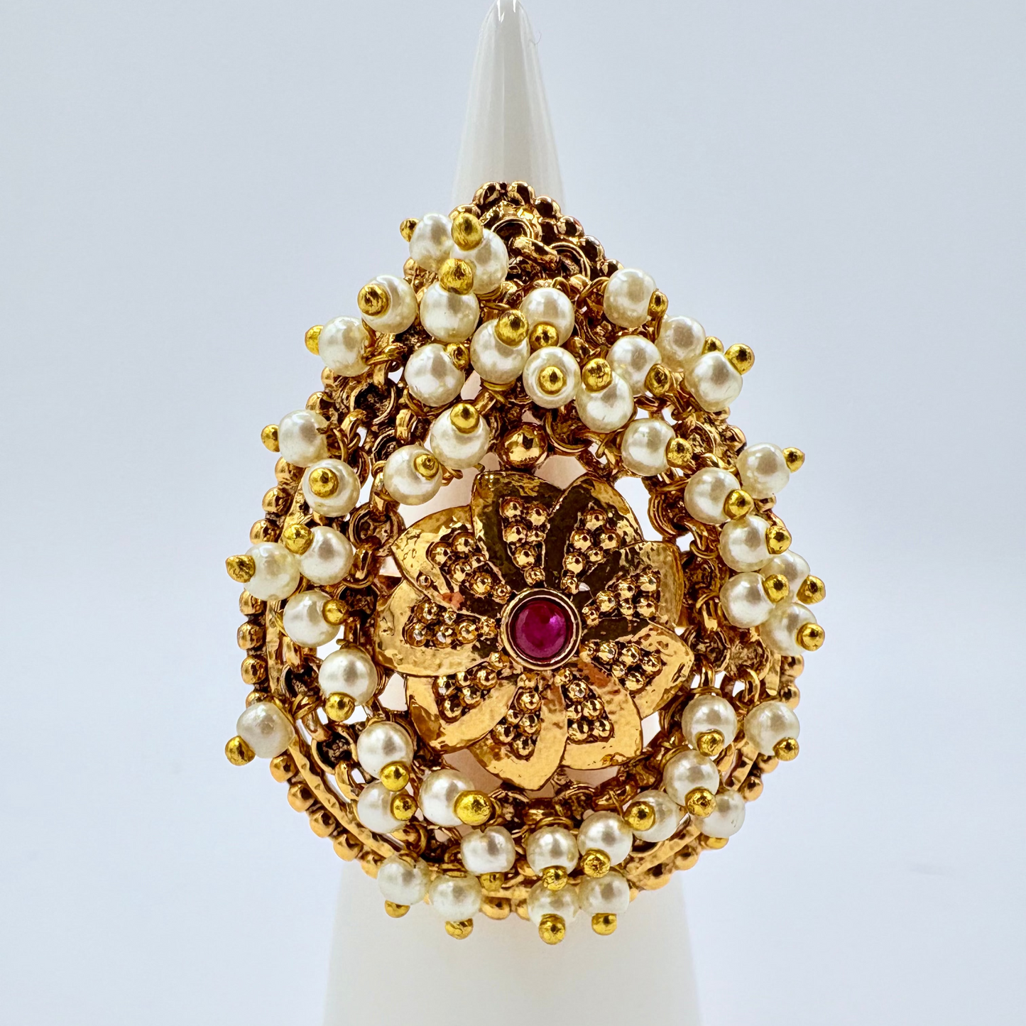 Decorative gold and pearl ring with red ruby in the middle  available at Nishaani.ca – Indian jewelry in Canada