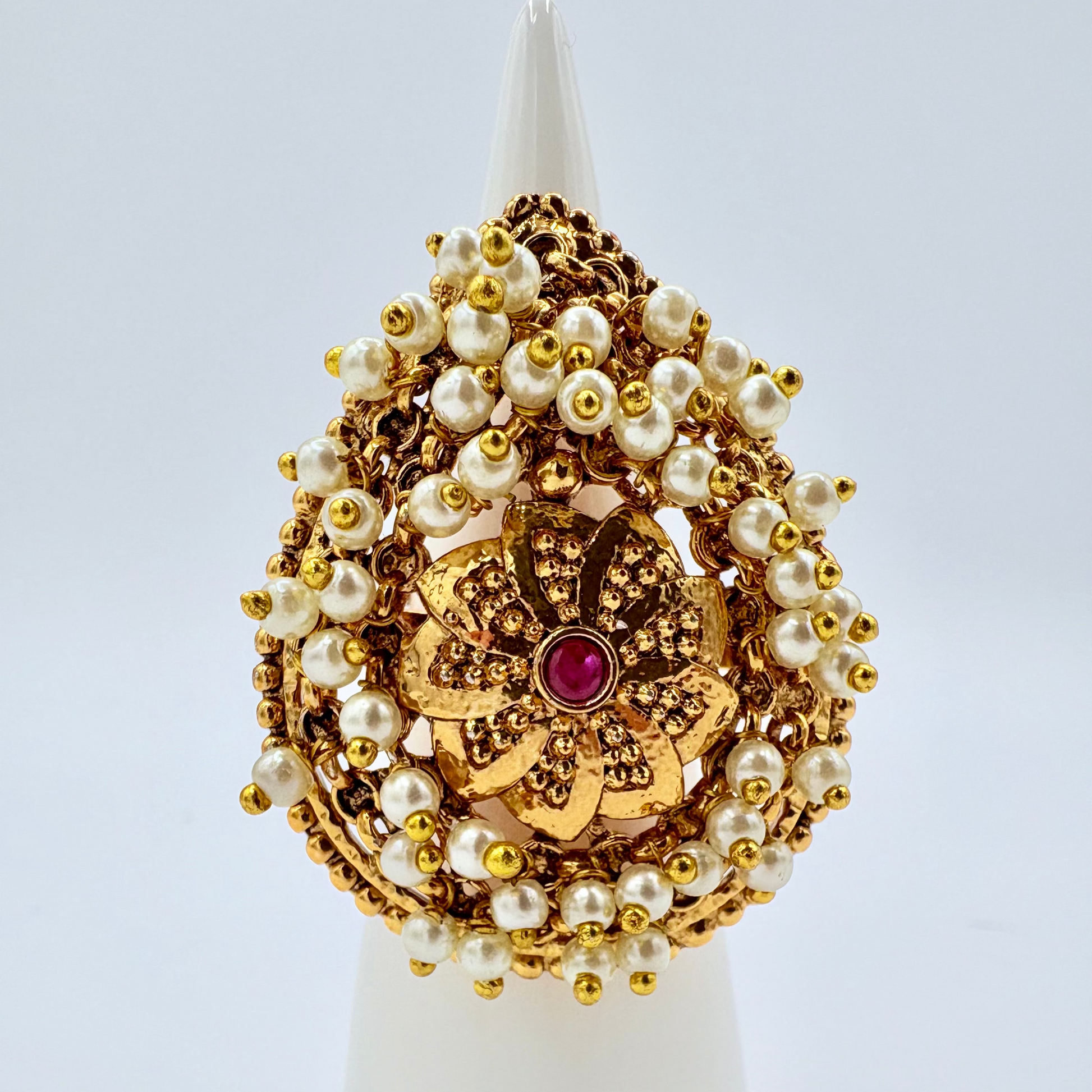 Decorative gold and pearl ring with red ruby in the middle  available at Nishaani.ca – Indian jewelry in Canada