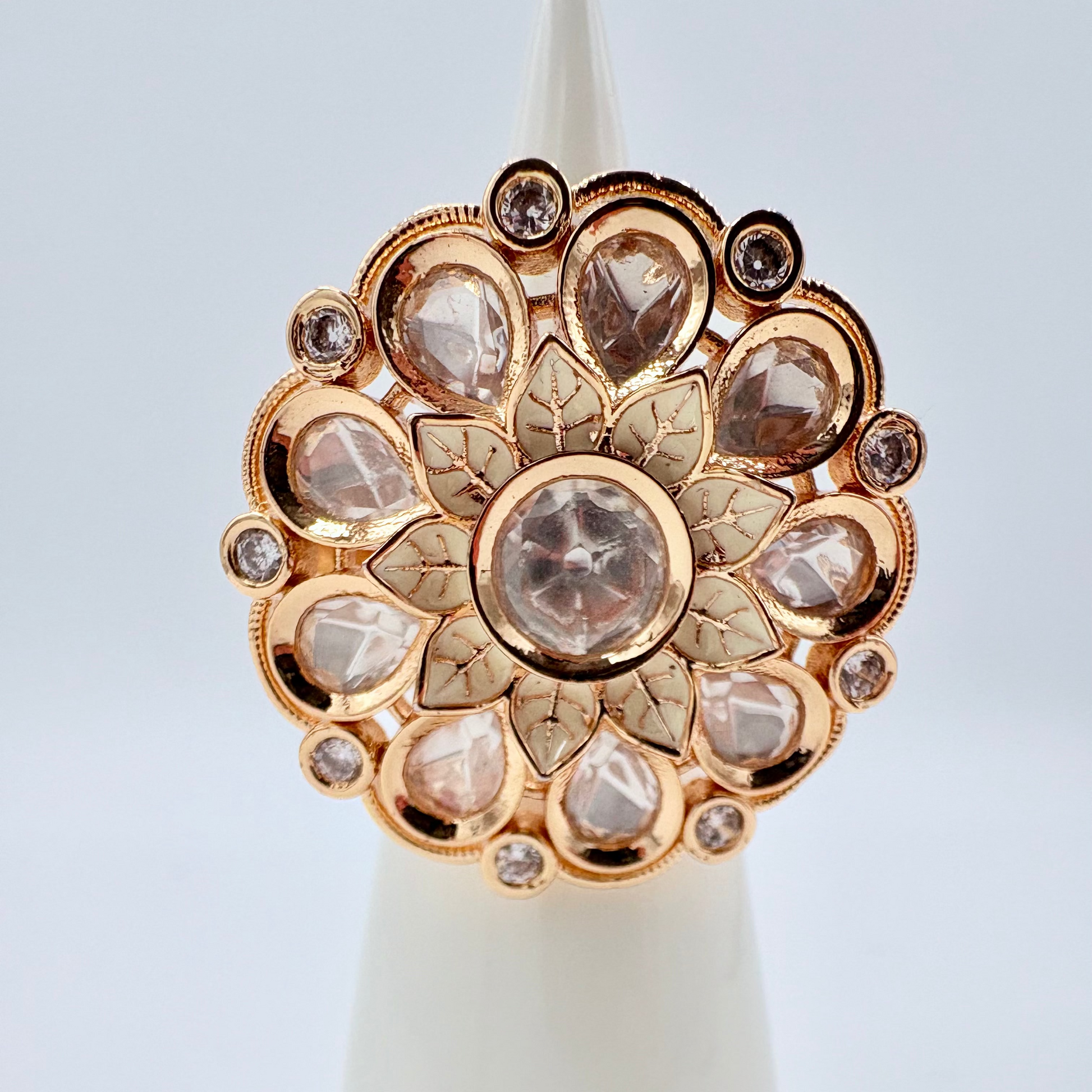 Gold ring with diamond like gems gold flower in the middle available at Nishaani.ca – Indian jewelry in Canada
