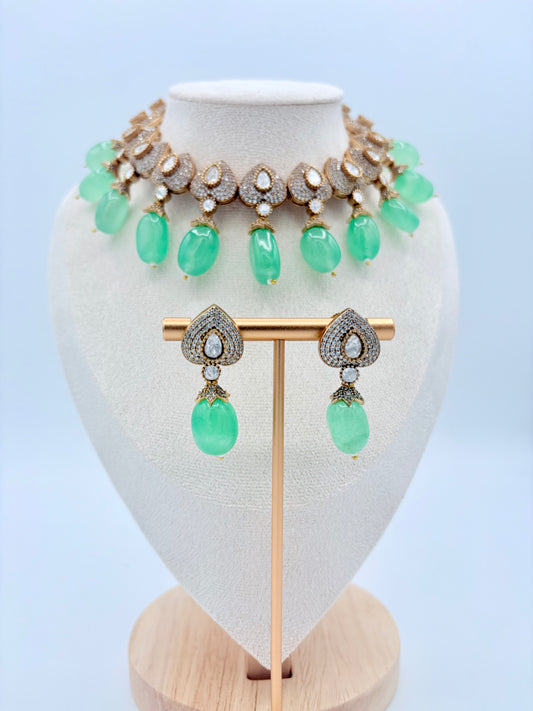 Jewelry set with green gemstones on a mannequin available at Nishaani.ca – Indian jewelry in Canada
