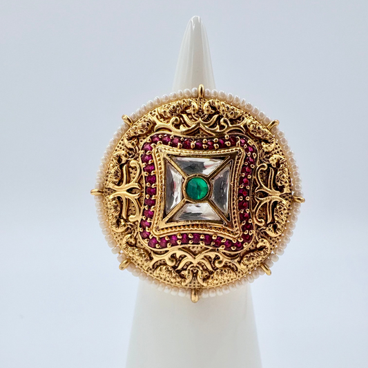 Decorative ring with gold, red gemstones, and a green stone available at Nishaani.ca – Indian jewelry in Canada