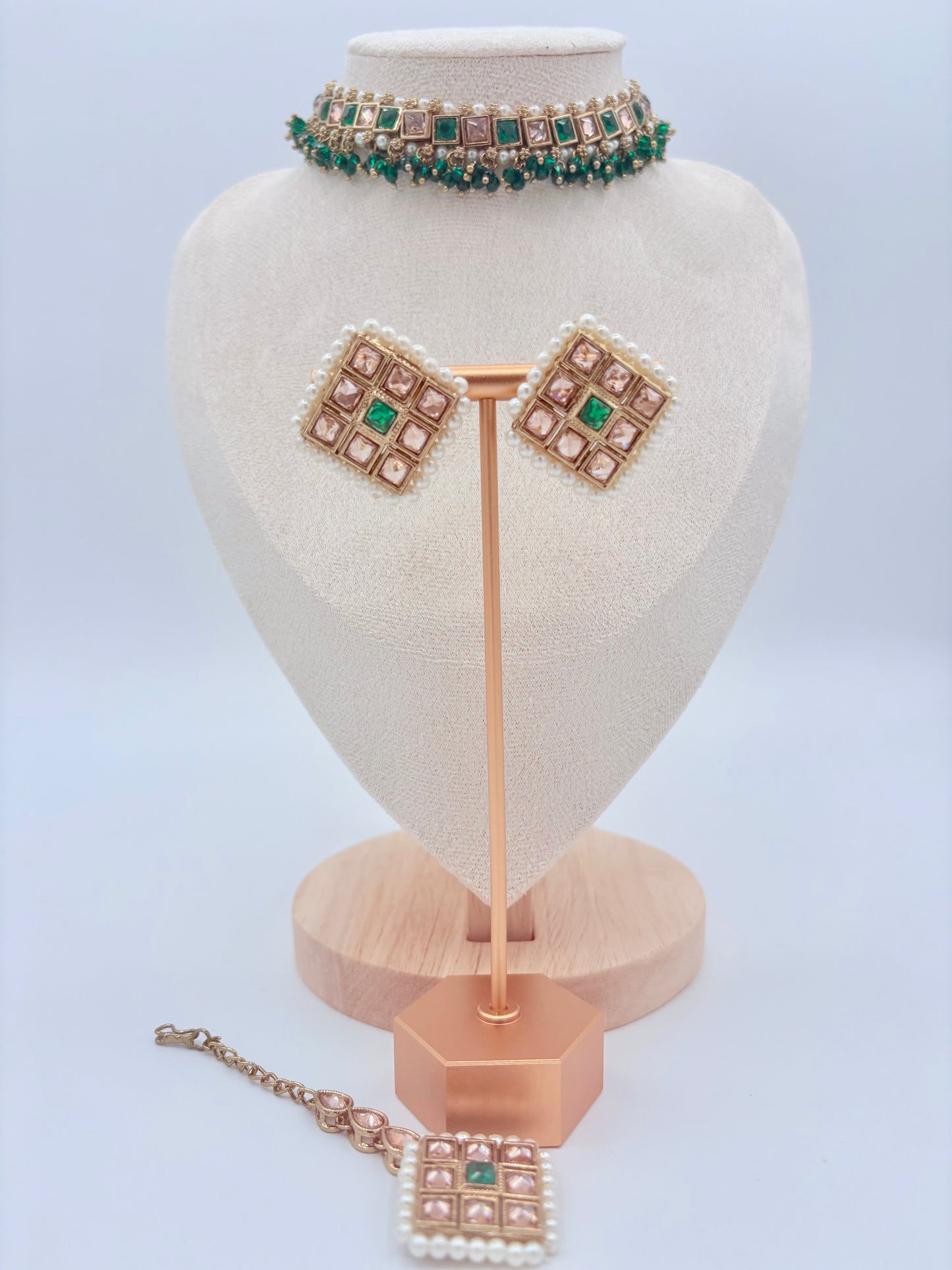 Choker set including necklace, earrings, and tikka on a heart-shaped stand available at Nishaani.ca – Indian jewelry in Canada