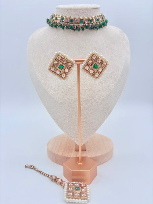 Choker set including necklace, earrings, and tikka on a heart-shaped stand available at Nishaani.ca – Indian jewelry in Canada